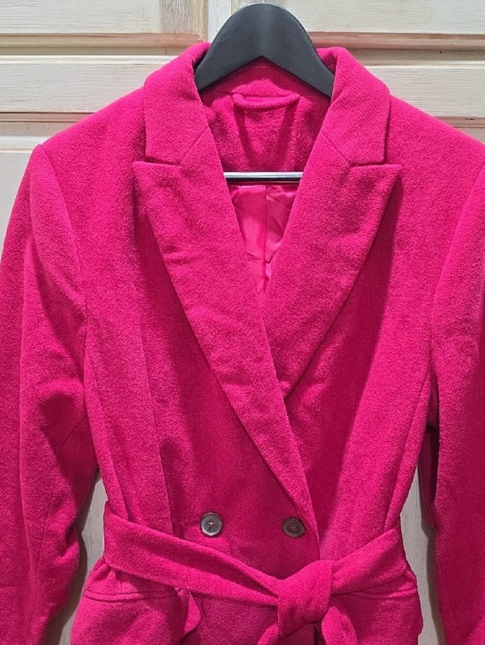 Fuchsia pink long coat features a clean single-button front closure. NWOT